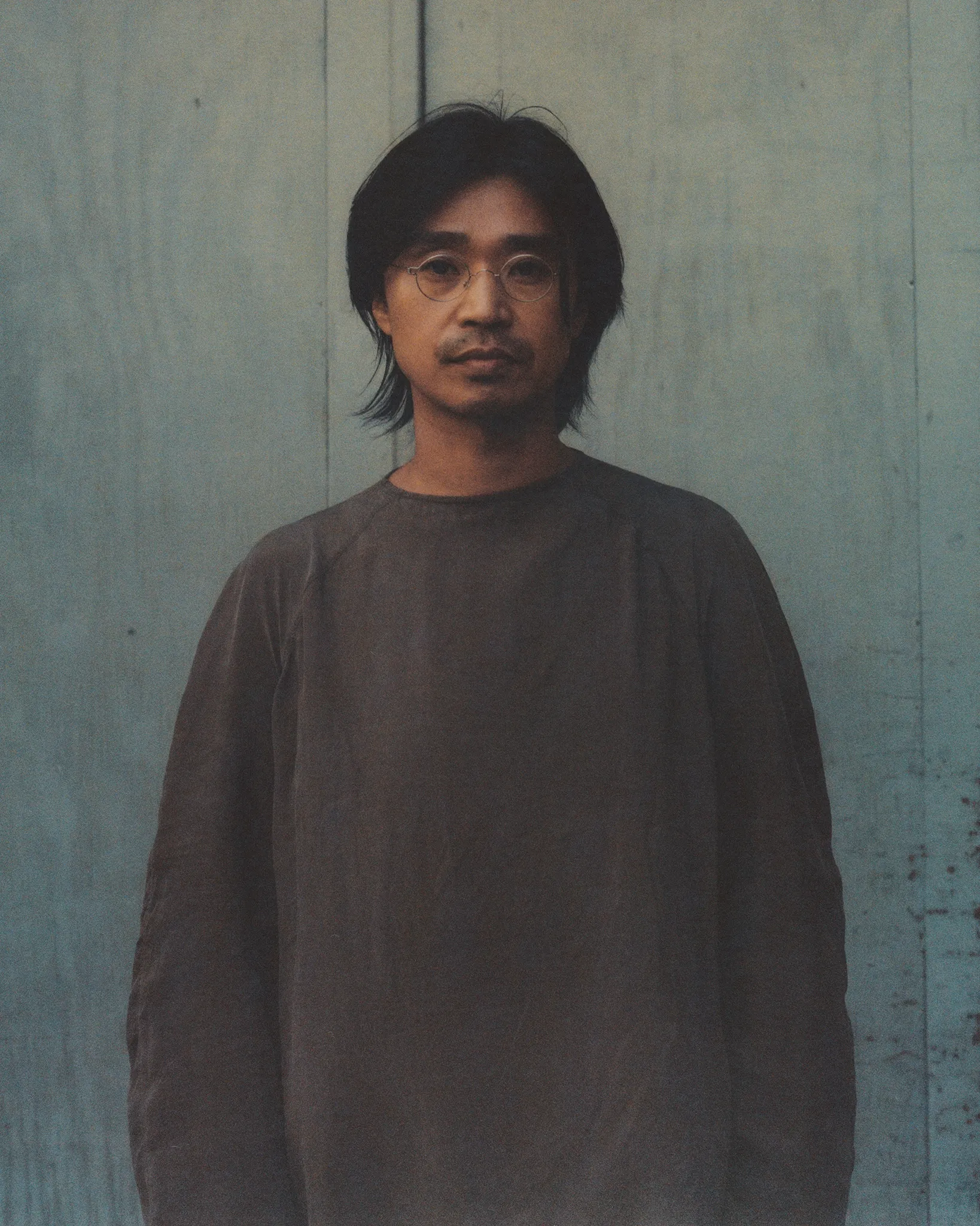 Tōsei bent over the pottery wheel, and a portrait of Huh Namhoon