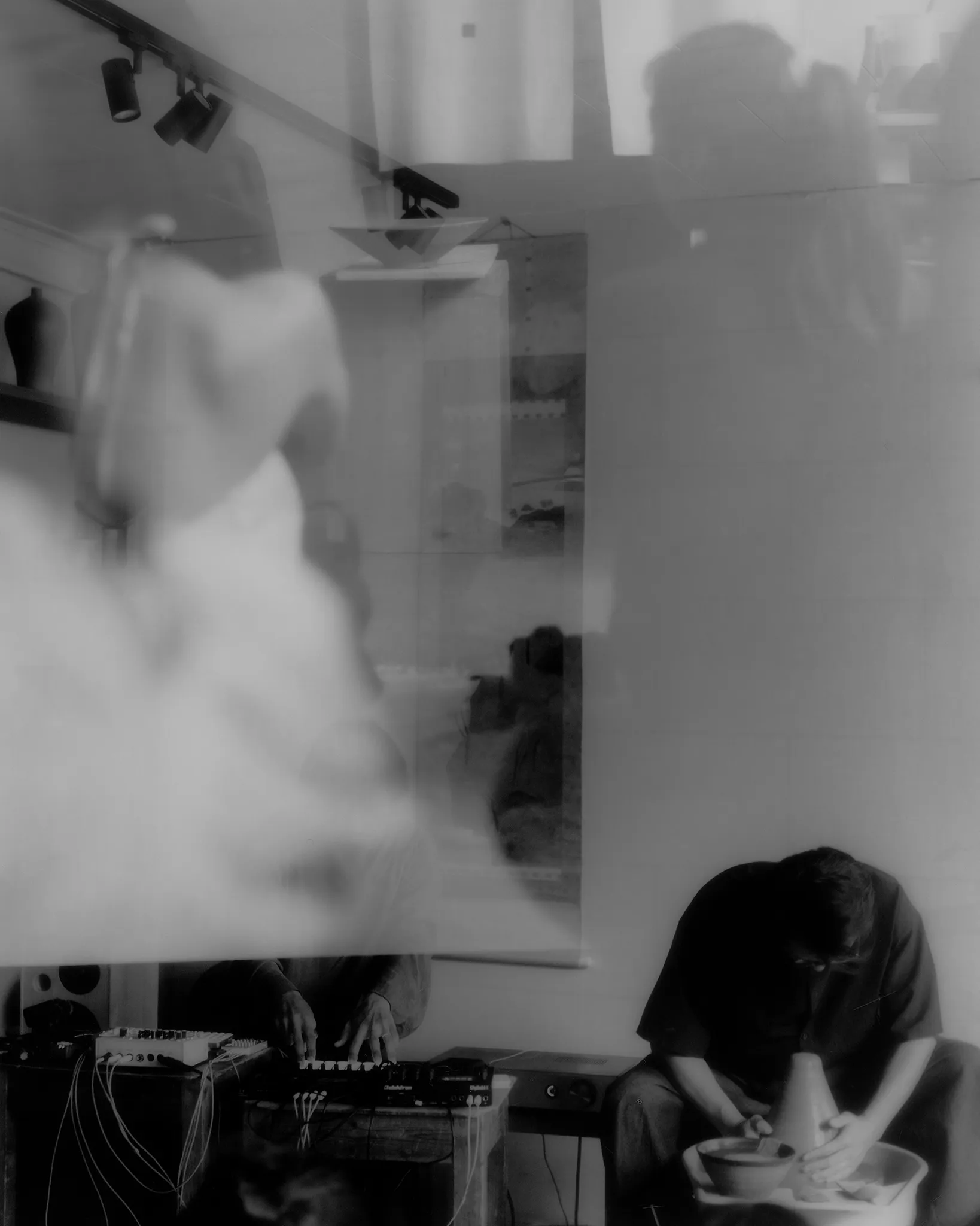 The performance seen through the audience, and Huh Namhoon at his equipment among the ceramics