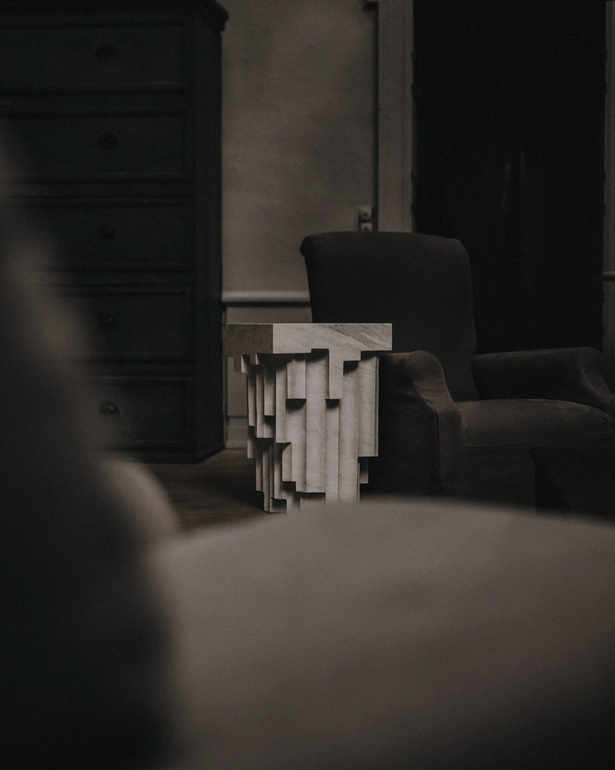 Sculptural side table in a dim interior