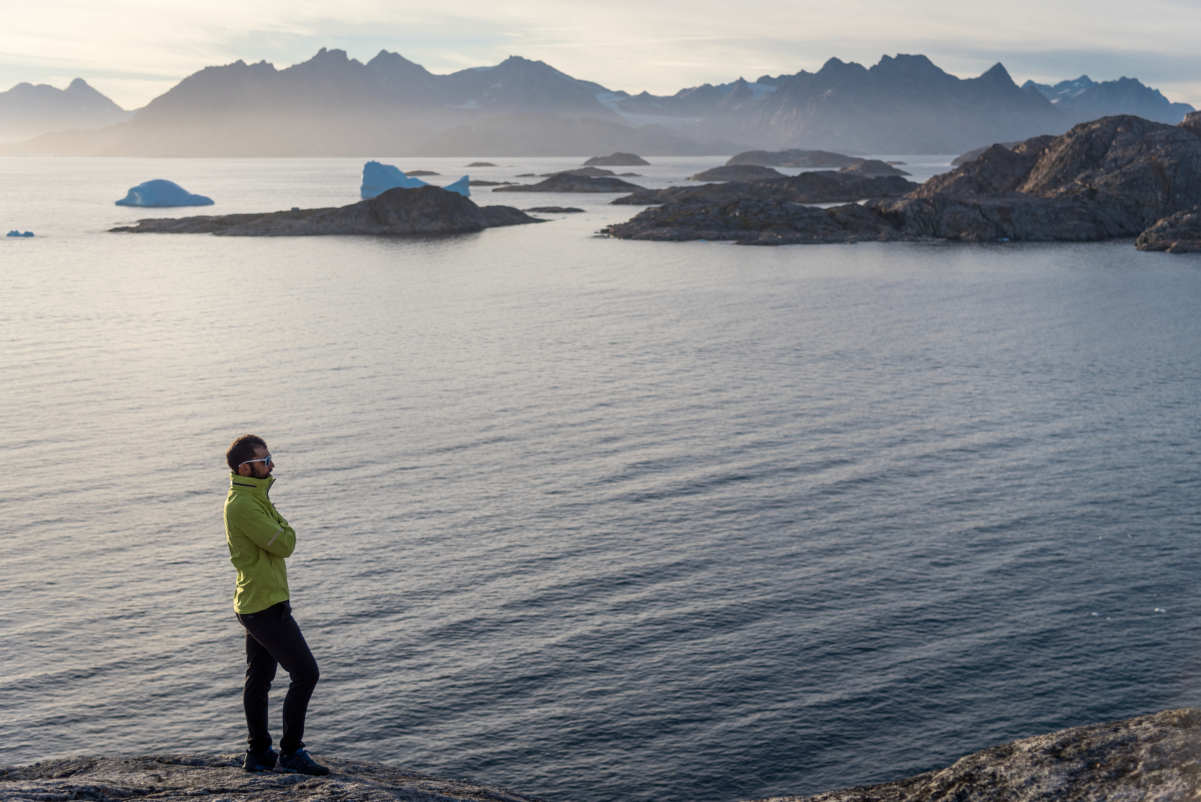 Hiker on shore on Kulusuk Island. Photo - Chris B. Lee, Visit Greenland