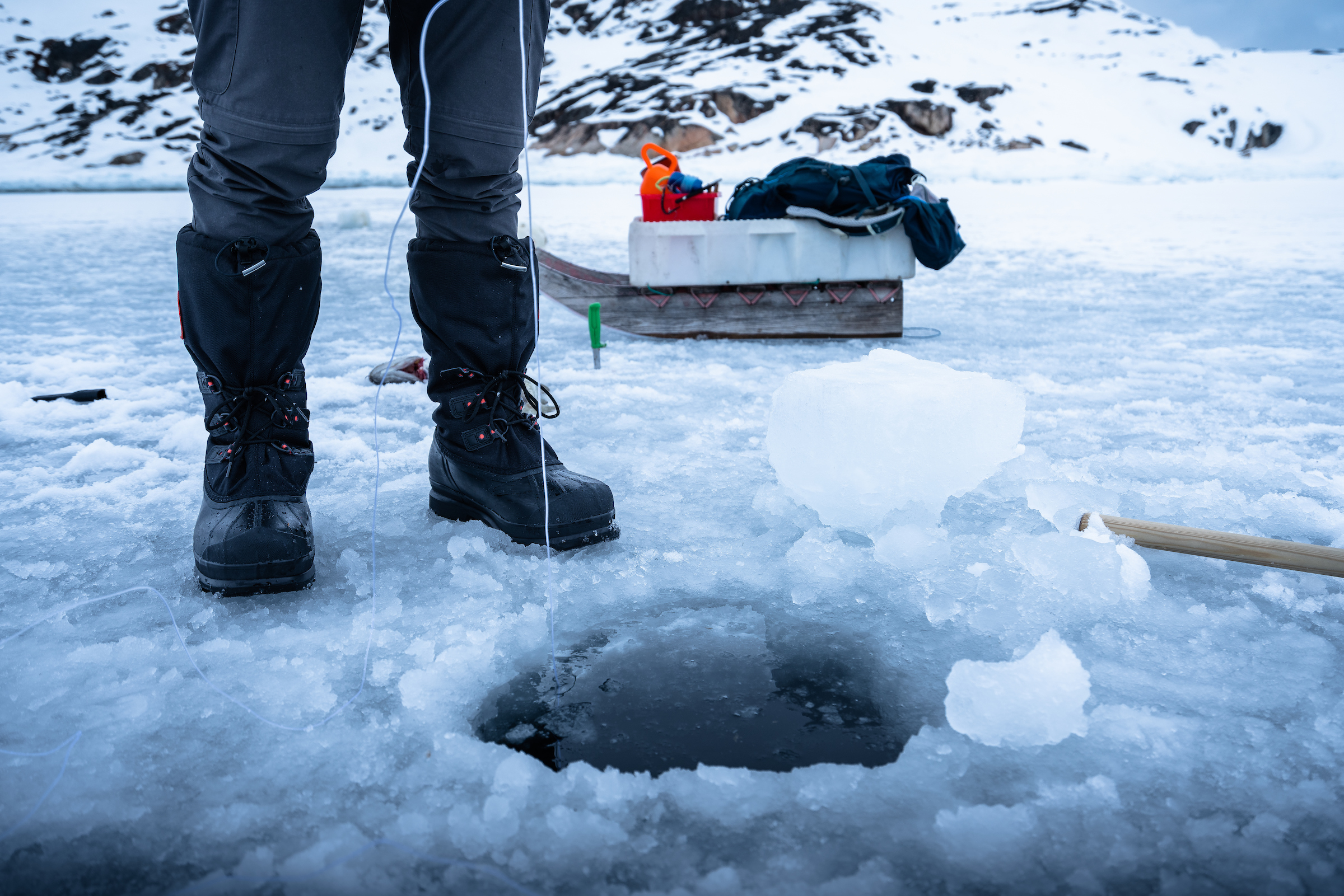 Ice fishing in the Aasiaat backcountry. Photo by Alex Savu - Visit Greenland